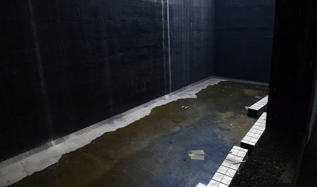 Waste is temporarily stored in a massive tank.