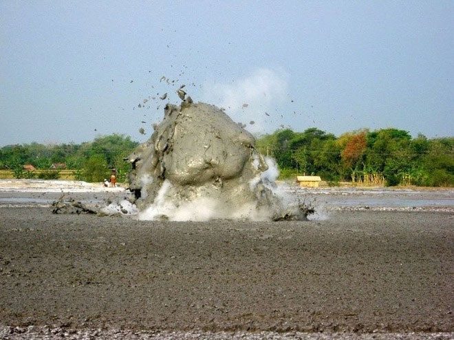 Mud, fluid, and gas erupting on the Earth's surface.