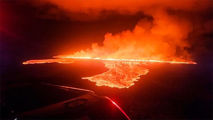 Smoke and lava erupting as the volcano is active on the Reykjanes Peninsula