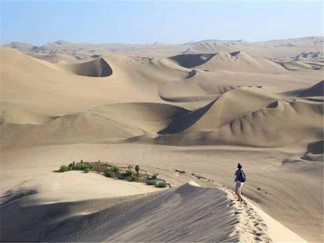 The town is surrounded by towering sand dunes