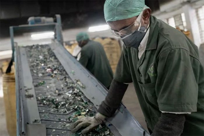 Workers sorting electronic waste in a factory in India