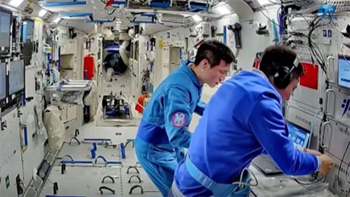 Chinese astronauts conducting research on Tianhe Space Station