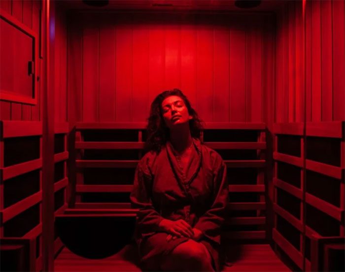 A woman sitting in an infrared sauna