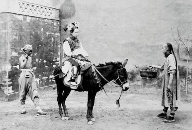 A noble Manchu woman riding a donkey