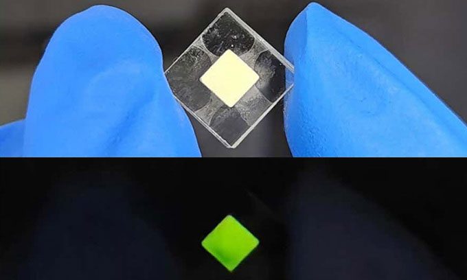 Americium-containing luminescent crystal in bright environment (top) and dark environment (bottom).