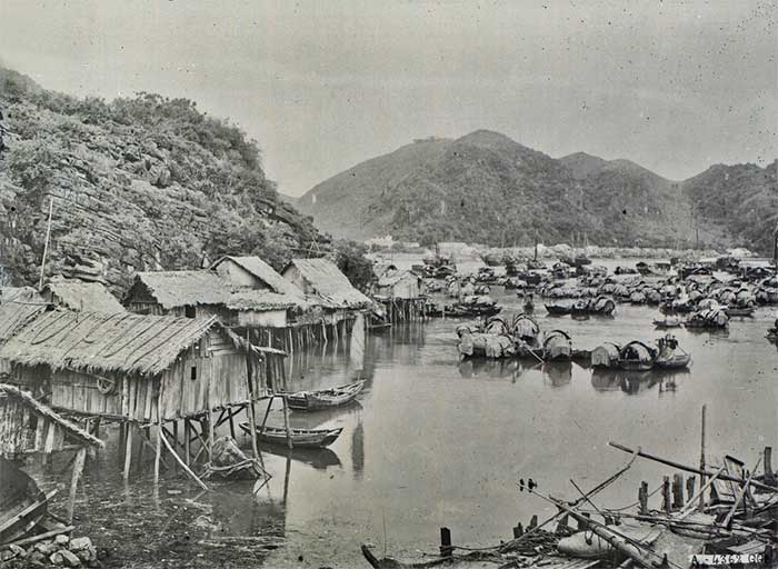 Near the sea, fishing villages nestled against the rocky mountains in Ha Long Bay.