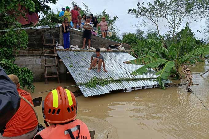 Philippine Coast Guard evacuating residents from flooded areas in Libon town, Albay province.