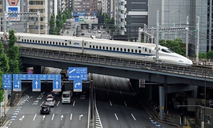 Bullet train running on elevated tracks in central Tokyo.