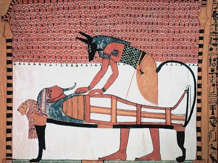 Anubis participating in the mummification process.