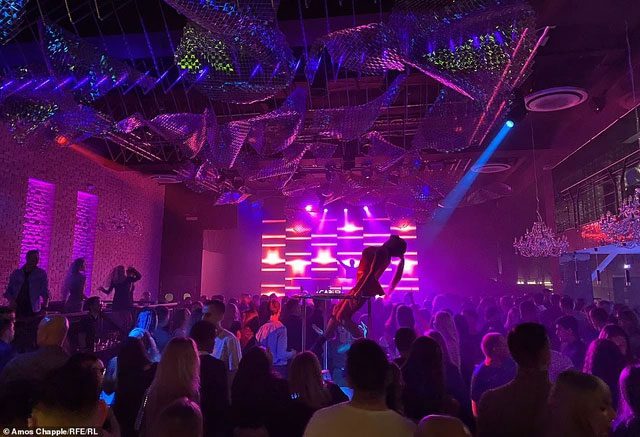 Despite the cold outside, a nightclub in the city center is lively and vibrant.