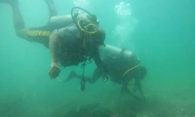 Diver exploring the wreck site.