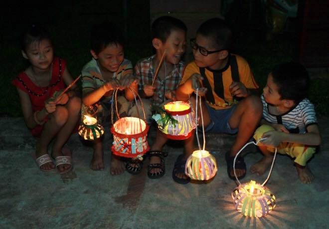 The whole neighborhood gathers, each child holding a lantern, celebrating the moon together...