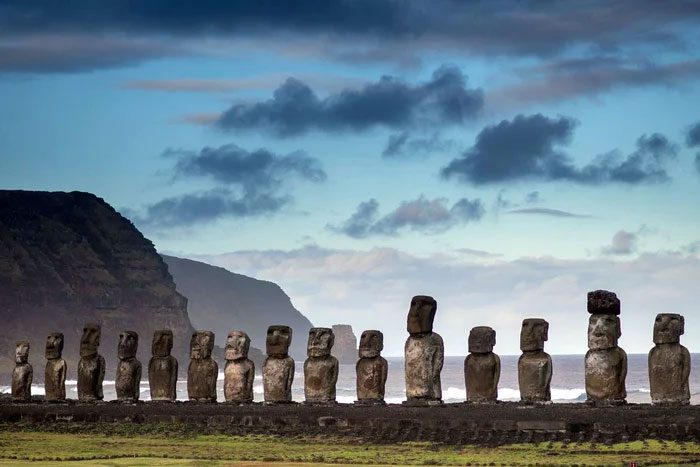 The monolithic statues face the village.