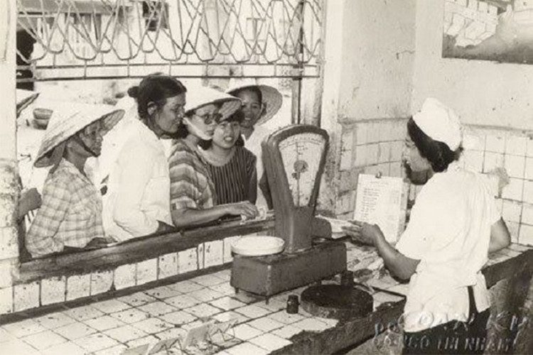 People waiting in line to buy meat.