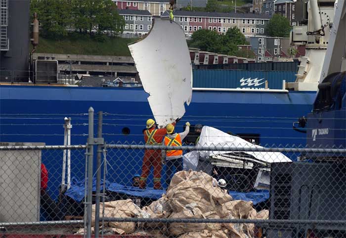 Debris from the Titan submersible being brought up in St. John's on June 28.