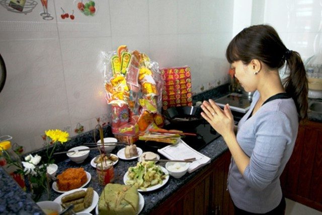 Preparing offerings for the Kitchen Gods.