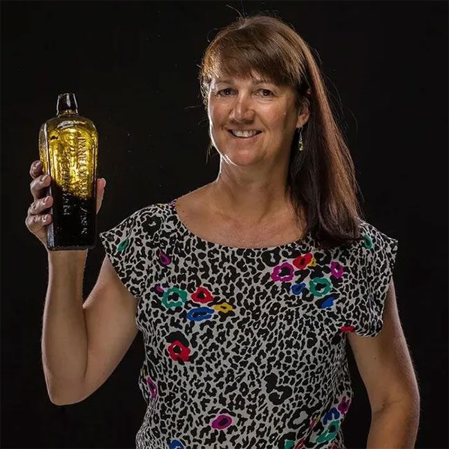 Mrs. Tonya Illman with the bottle found on the beach.