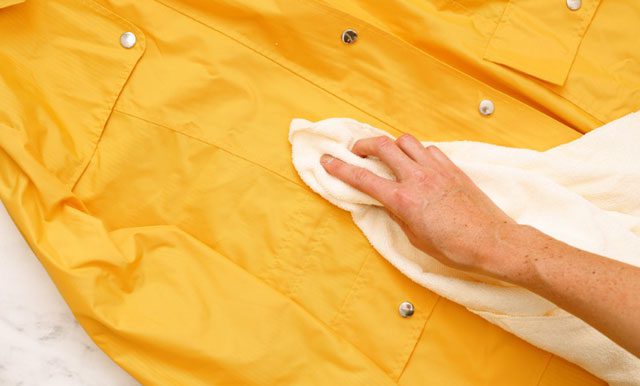 Once most dirt is removed, the raincoat is ready to be washed.