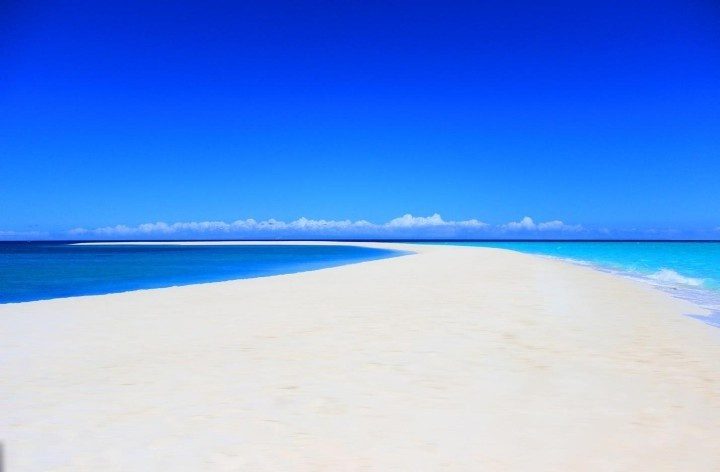 White sand formed from coral fragments containing calcium carbonate.