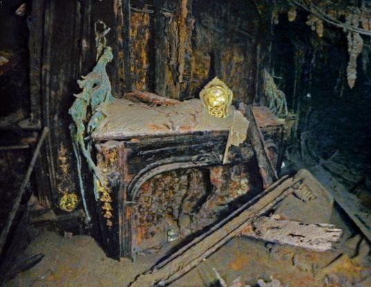 The intact gold clock on an electric fireplace