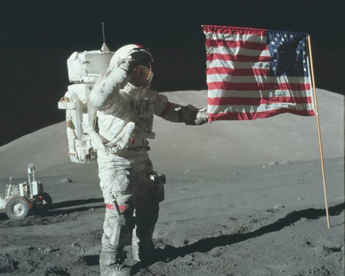 Apollo 17 astronaut Eugene Cernan planting the American flag on the Moon.