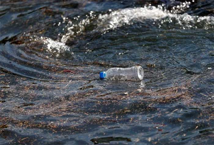 A plastic bottle drifting on ocean waves at a fishing port in Isumi, east of Tokyo, Japan.