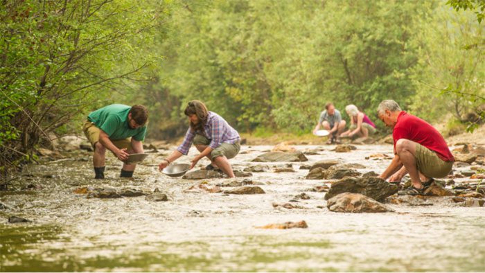 Tourists experience gold panning on the Klondike River