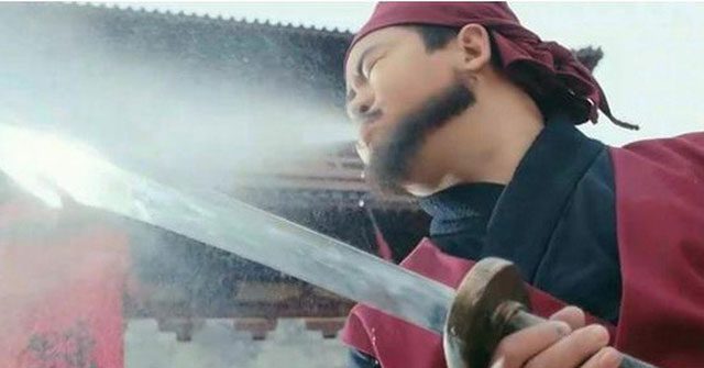 Executioner spitting wine onto the blade