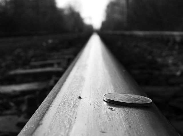 Placing a coin on the tracks does not cause a train to derail.