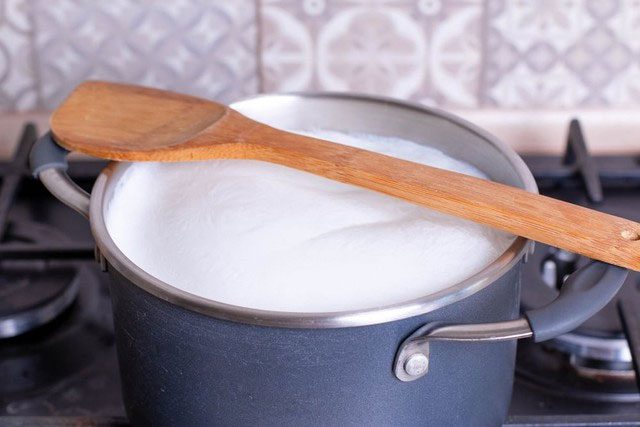 Placing a wooden spoon over the pot of milk is a temporary way to prevent spilling.