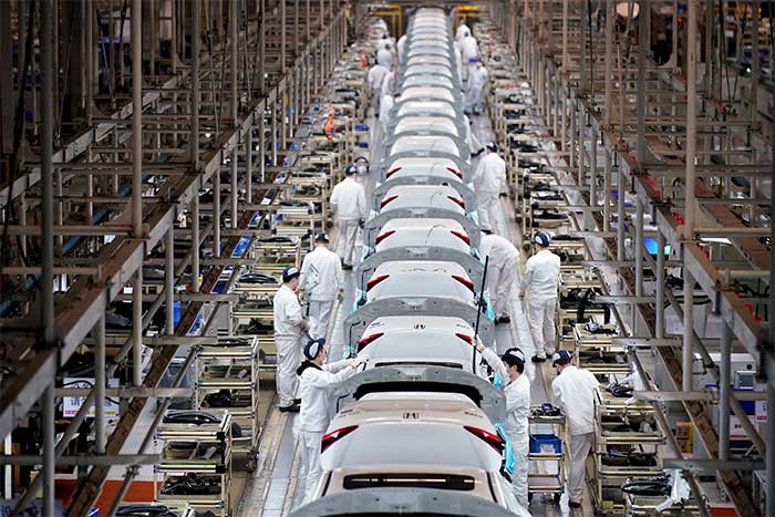 Employees working on an assembly line inside a factory in China