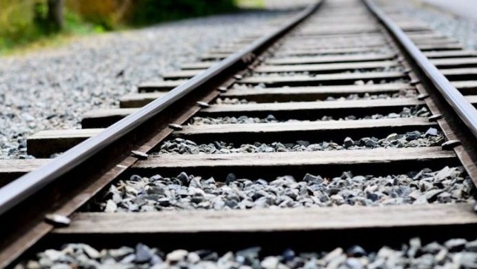 A layer of ballast laid along the railway tracks.