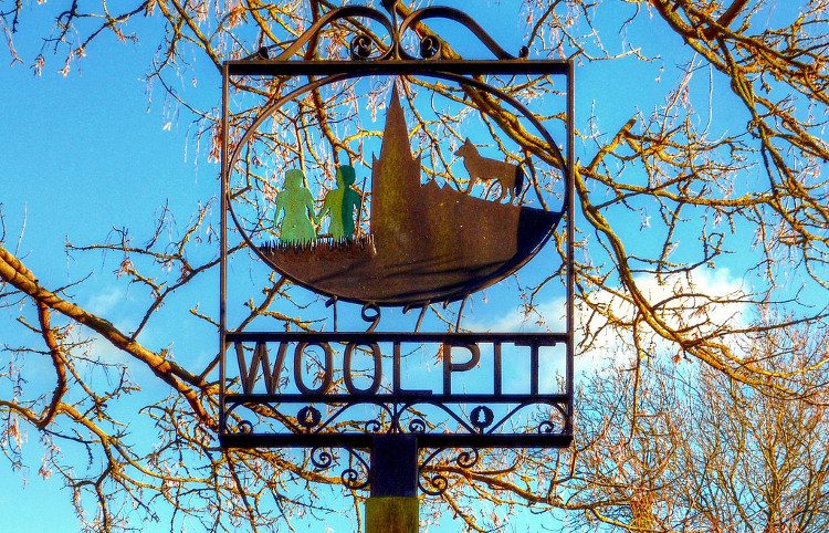 A sign in Woolpit village describing the legend of the two children from the 12th century.