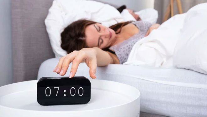 Place the alarm clock in a location that requires you to get out of bed to turn it off.