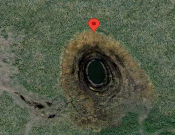 A mysterious deep hole found in the forest in Abyysky District, Sakha Republic, Russia.