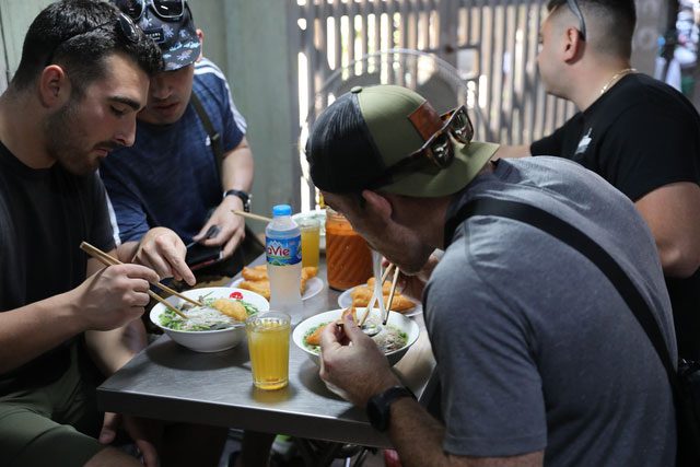 Foreign tourists enjoying pho