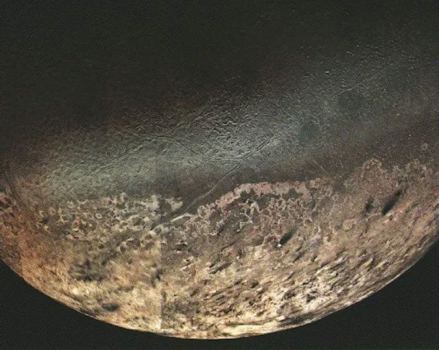 Triton, Neptune's moon, seen by Voyager 2 in 1989.