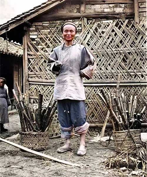 A rugged-looking man selling sugarcane by the roadside.