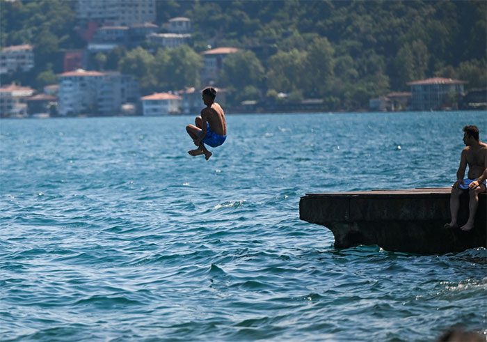 People swimming to cool off from the heat in Istanbul, Turkey, on July 18.