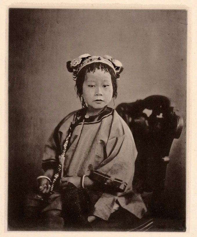 A wealthy girl, photographed in Guangdong around 1870.