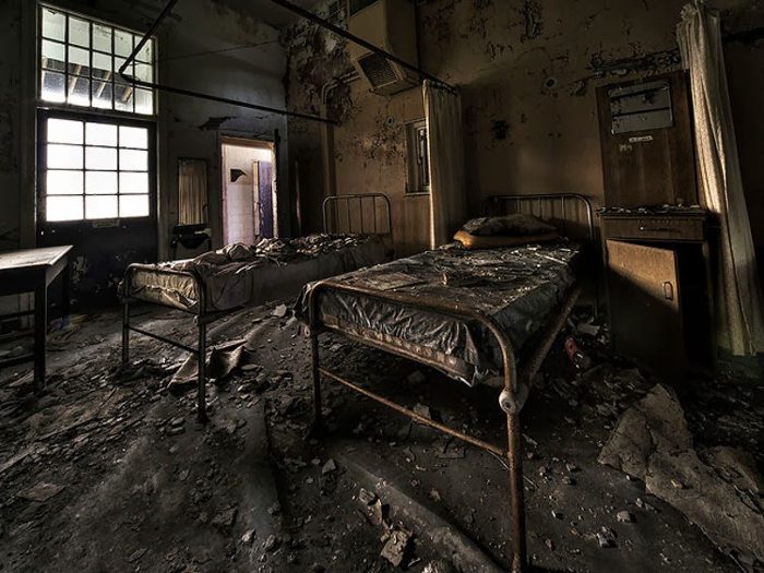 Many hospital beds and medical equipment left behind, scattered everywhere and deteriorating over the years, make this place frightening.