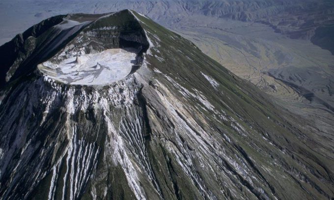 Ol Doinyo Lengai volcano ejecting superfluid black lava that turns white when dried.