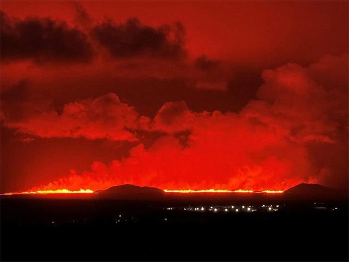 Bright red volcanic lava lighting up the sky in Iceland