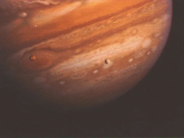 Jupiter and its two moons.