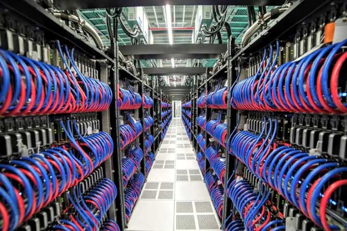 Thousands of chips and cooling water pipes inside the Frontier supercomputer.