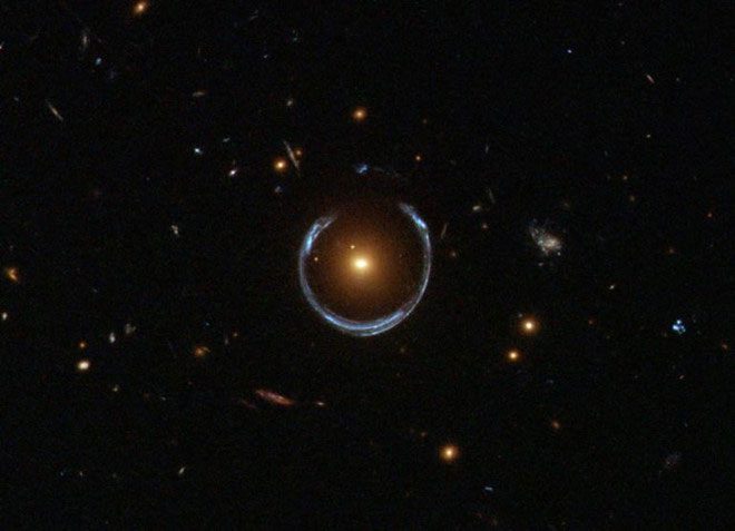 The Hubble Space Telescope observed a red galaxy bending the light of a much farther blue galaxy.