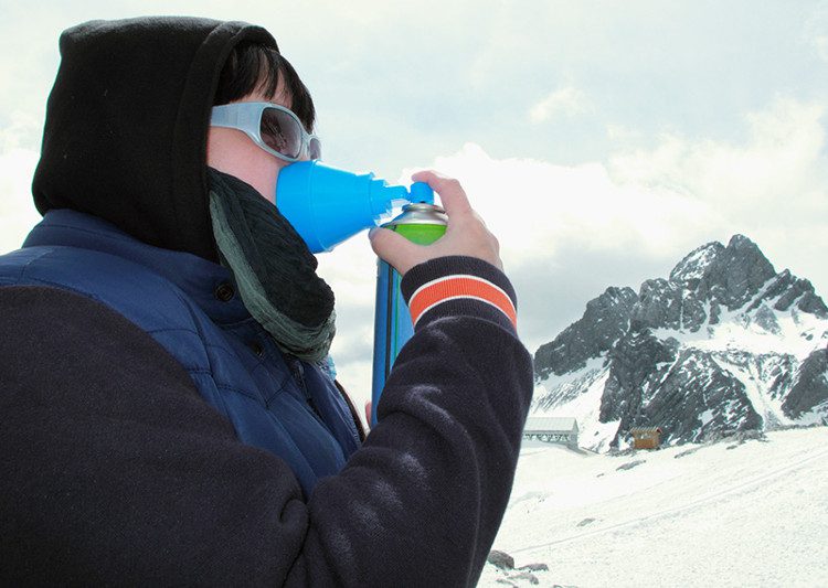 A girl suffering from altitude sickness breathes through an oxygen mask to prevent hypoxemia.