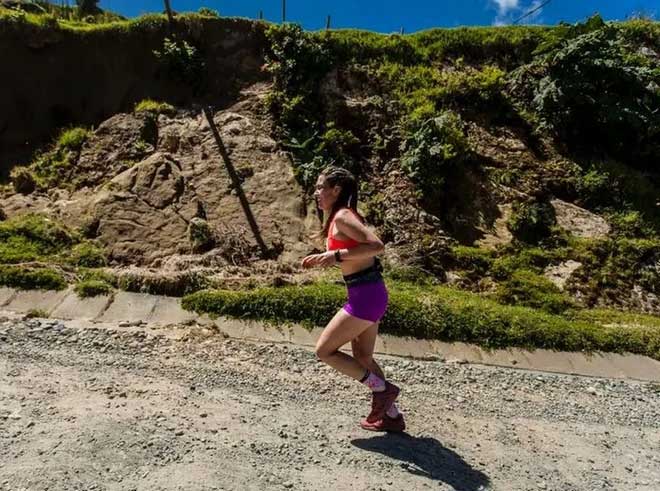 A female athlete running in San Juan De La Costa in Chile.