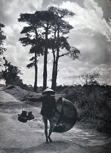 A farmer carrying tools to fish.