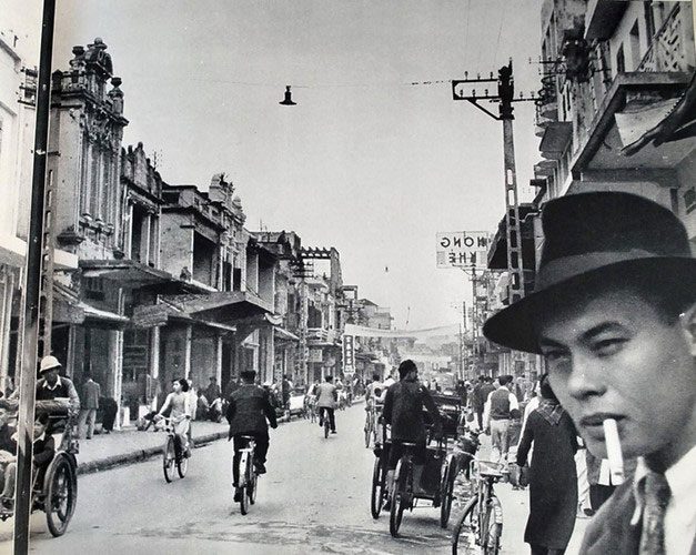 The bustling streets of Hanoi, Vietnam during the colonial era.